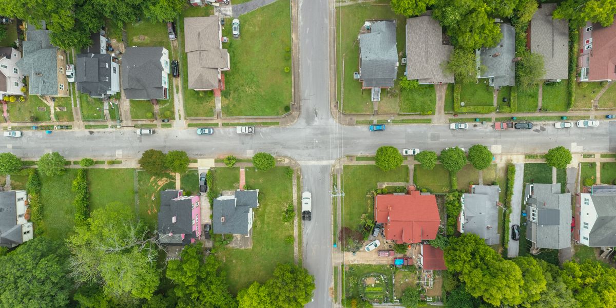 Aerial view of a suburban neighborhood with houses and green trees