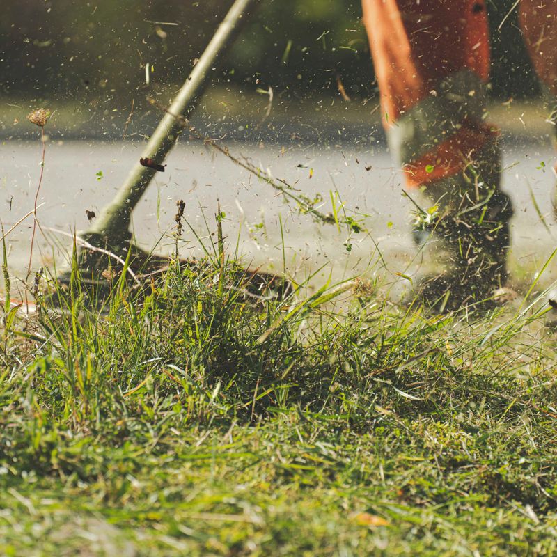 Landscaper working on a lawn, focused on the task at hand